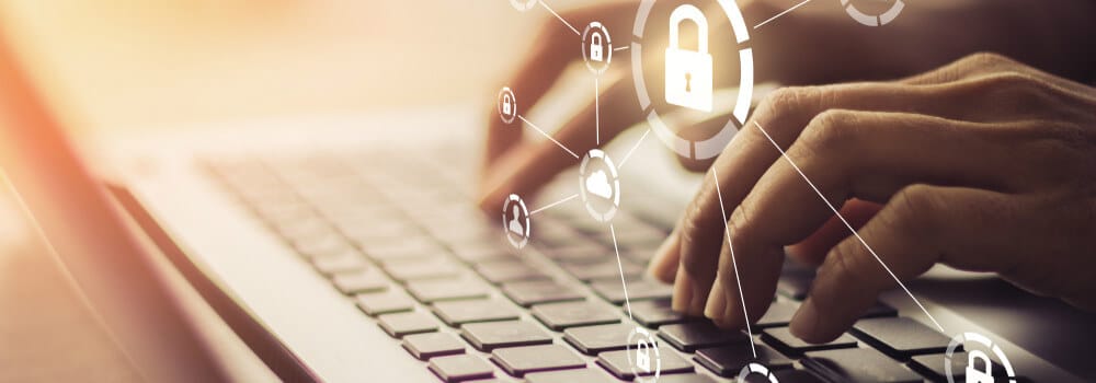 website security tips - person typing with security symbols overlaid